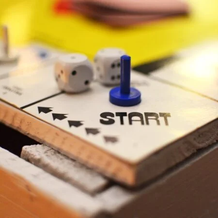 a game board with a few pieces of paper and a blue and white ball on top