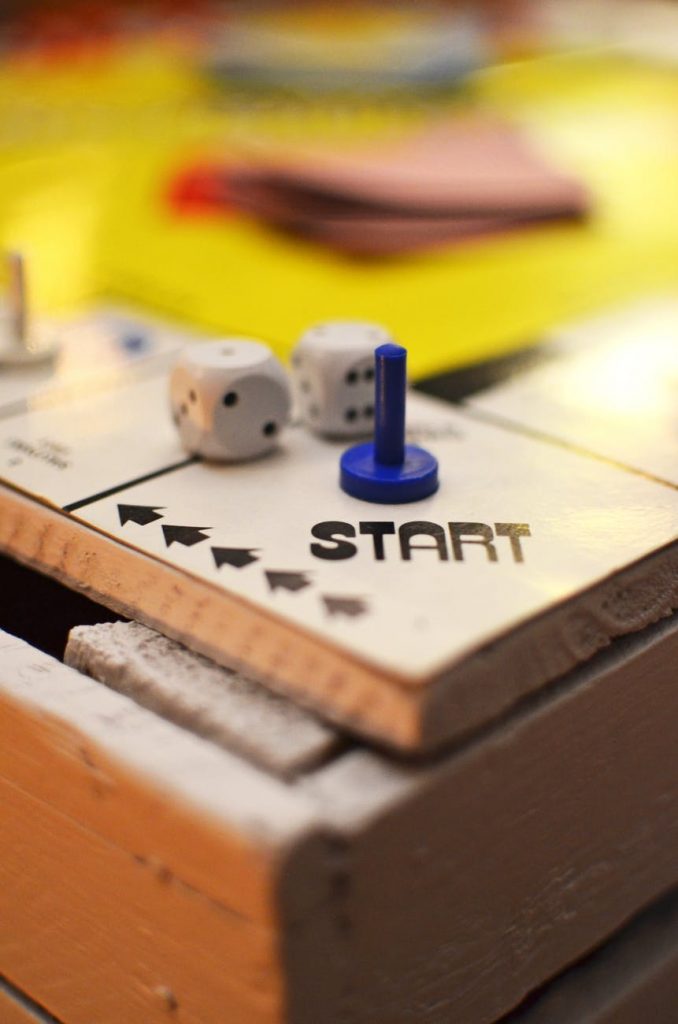 a game board with a few pieces of paper and a blue and white ball on top