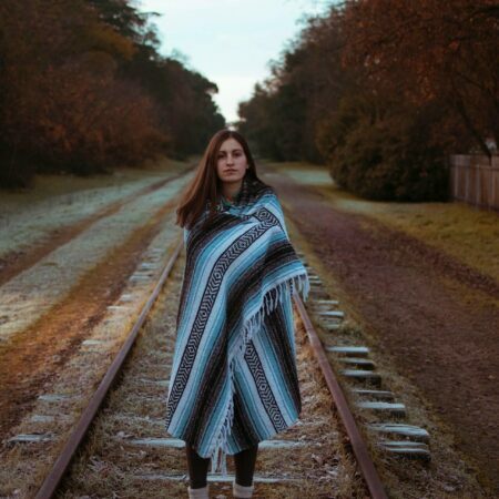 a woman standing on a railroad track
