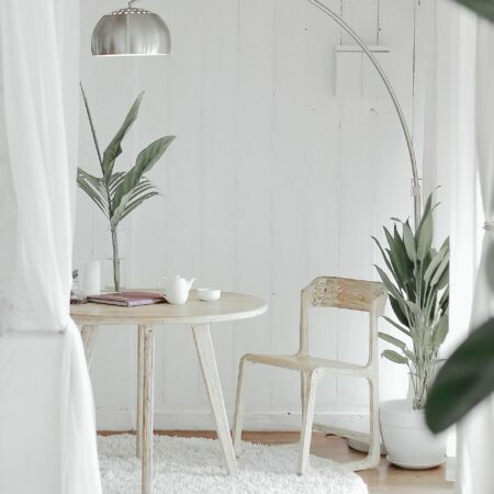 a white chair next to a table