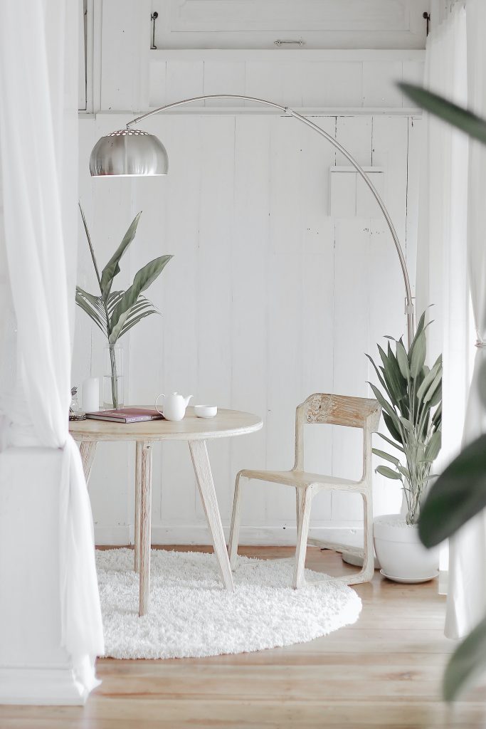 a white chair next to a table