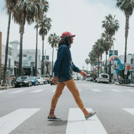 a man walking across a crosswalk