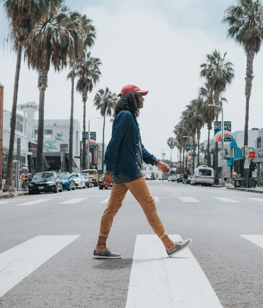 a man walking across a crosswalk