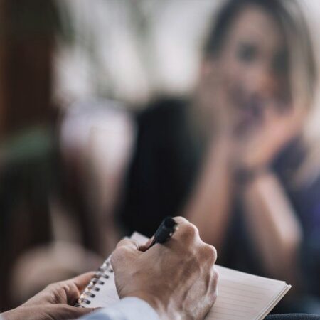 a person writing on a piece of paper