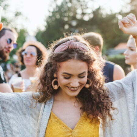 a person smiling with a crowd behind the