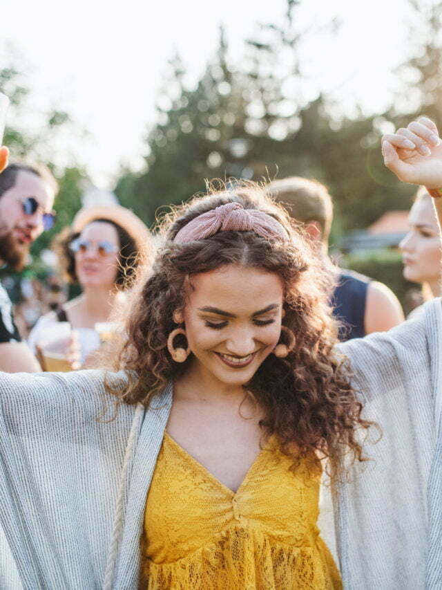 a person smiling with a crowd behind the