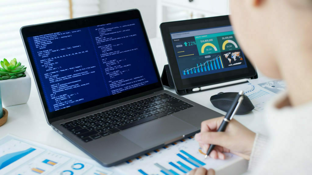 Back rear view of young asian woman, freelance data scientist work remotely at home coding